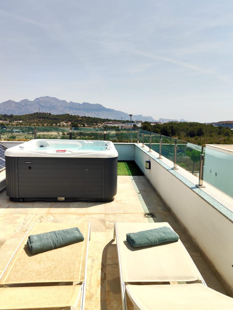 Rooftop avec jacuzzi, transats et vue sur la Sierra de Bernia.